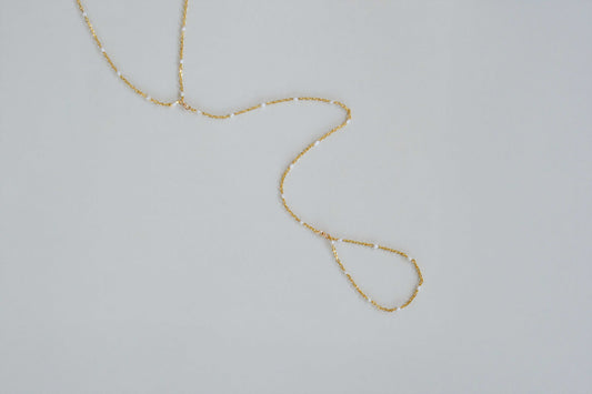 18K gold-filled thin dainty hand chain with white enamel detail close-up