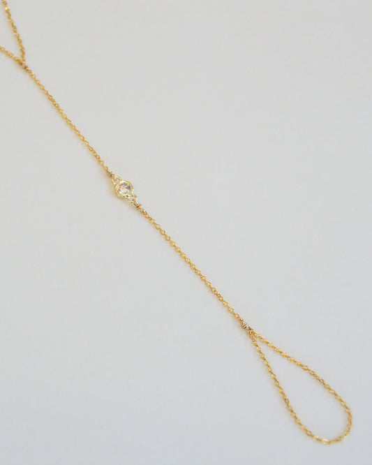18K gold-filled thin dainty hand chain with bezel detail close-up