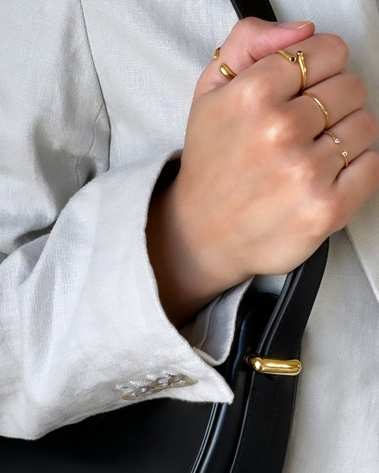 Model golding Prada purse wearing gold rings