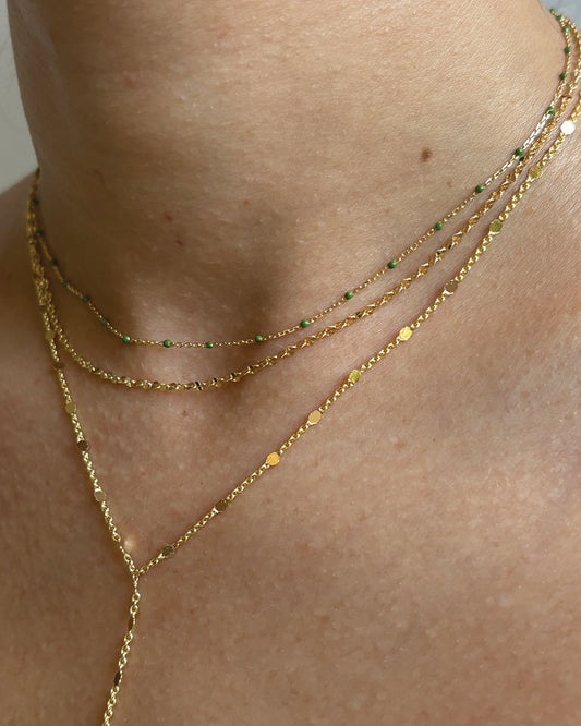 Model wearing dainty minimalist gold-filled necklace stack