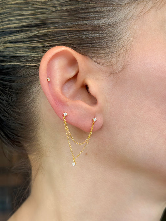 Sterling silver double chain earrings for two piercings on model's ear