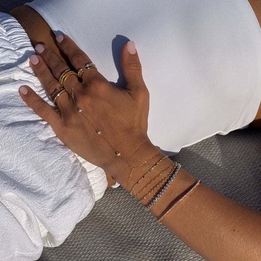 Minimalist gold filled hand chain with pearls on model’s hand