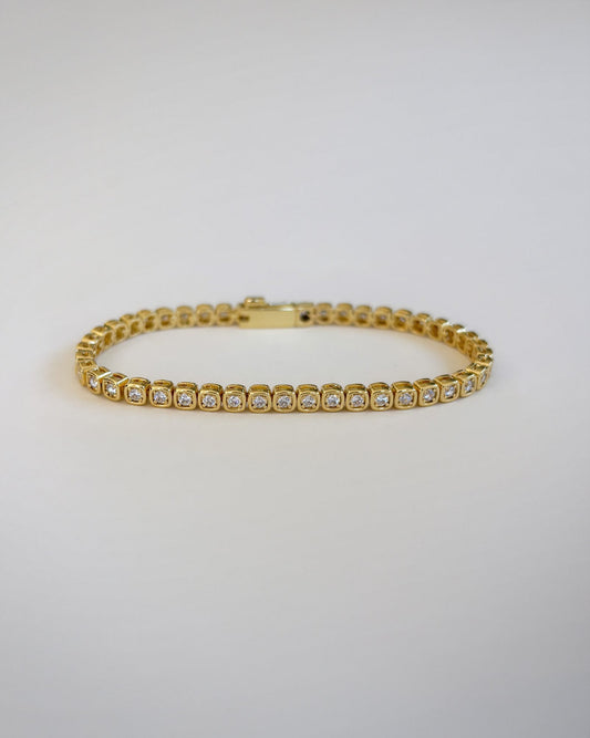 Square bezel tennis bracelet close-up in gold