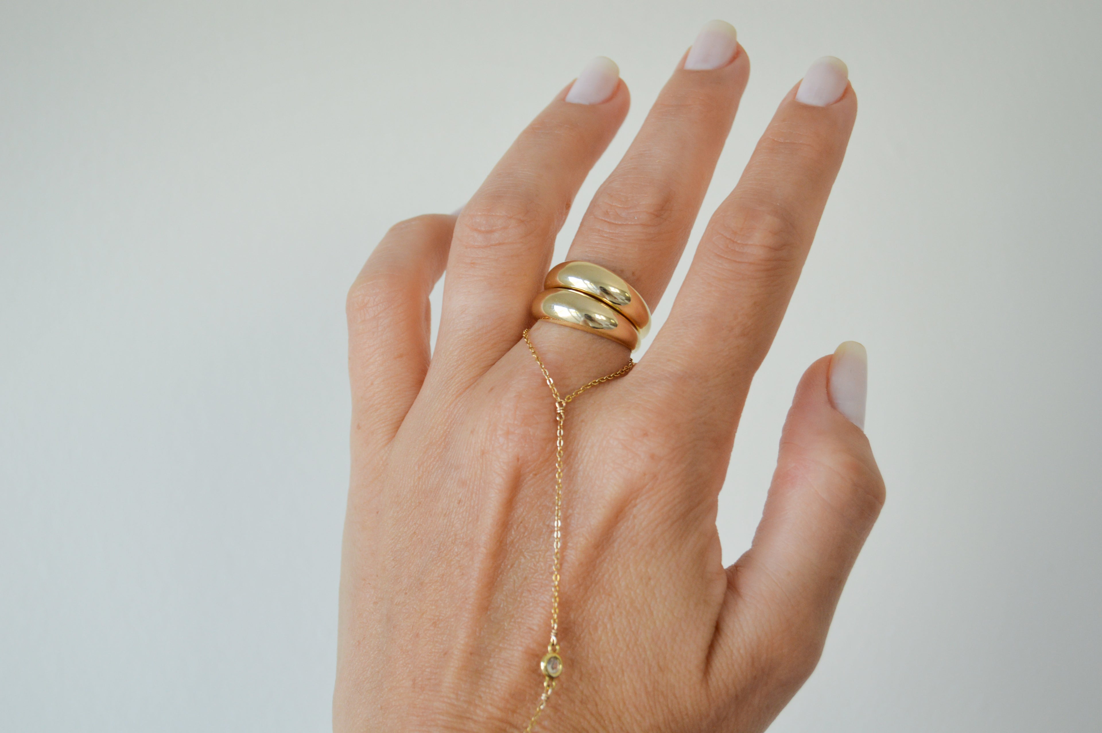 Model stacking two 18K gold-filled bold modern ring with timeless design