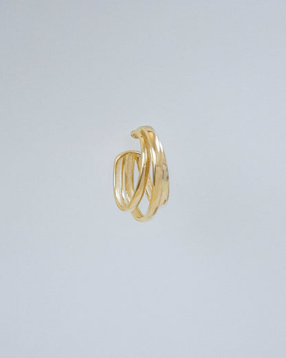18K gold-filled oversized cuff featuring three parallel lines close-up